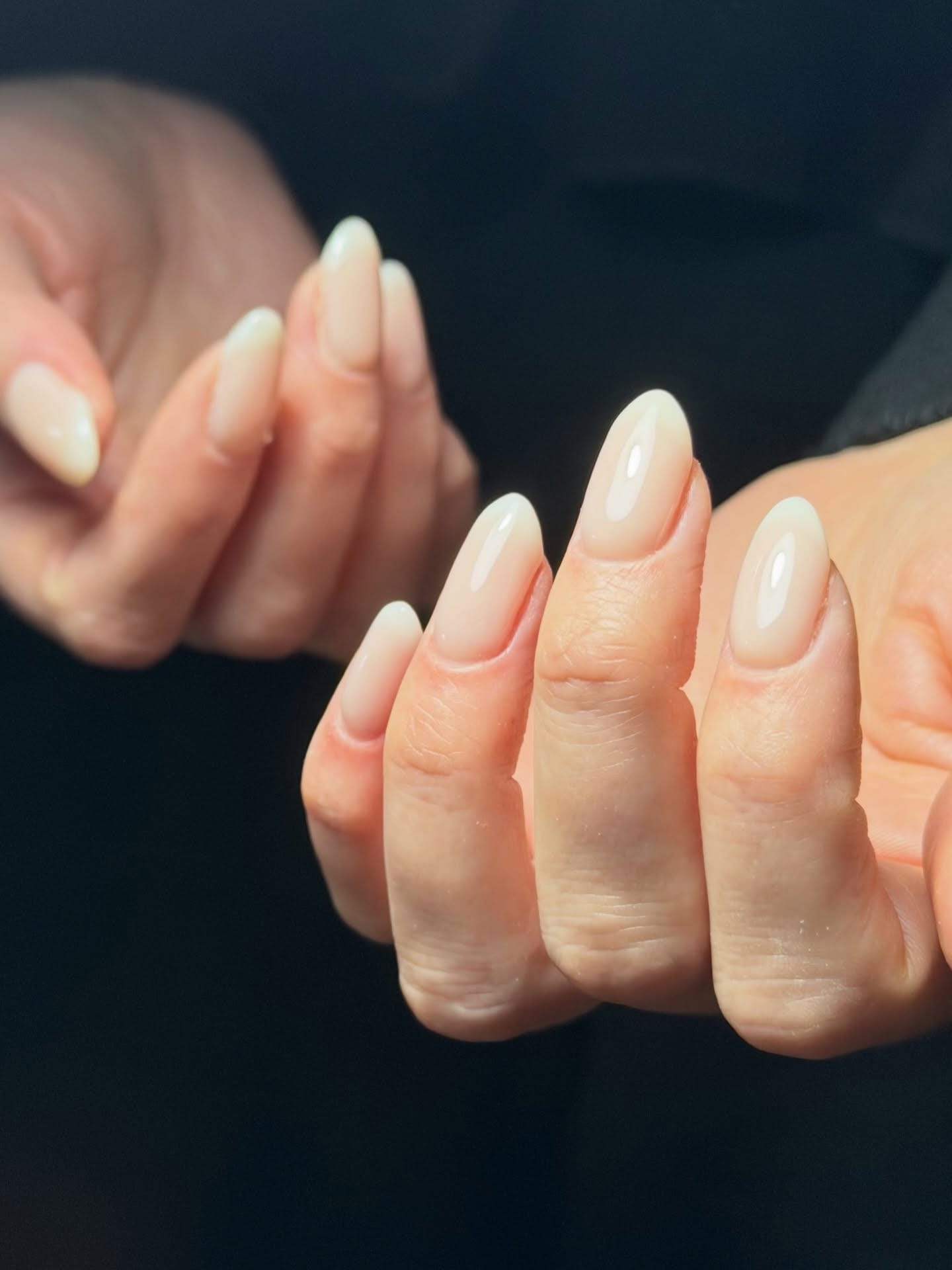 Milky gel manicure against black